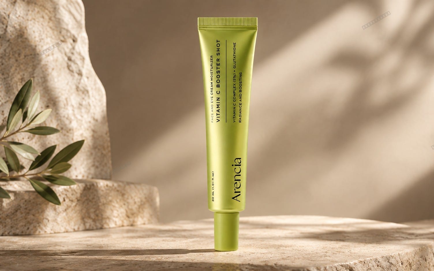 Luxury green skincare cream tube on beige stone pedestal with soft botanical leaves background