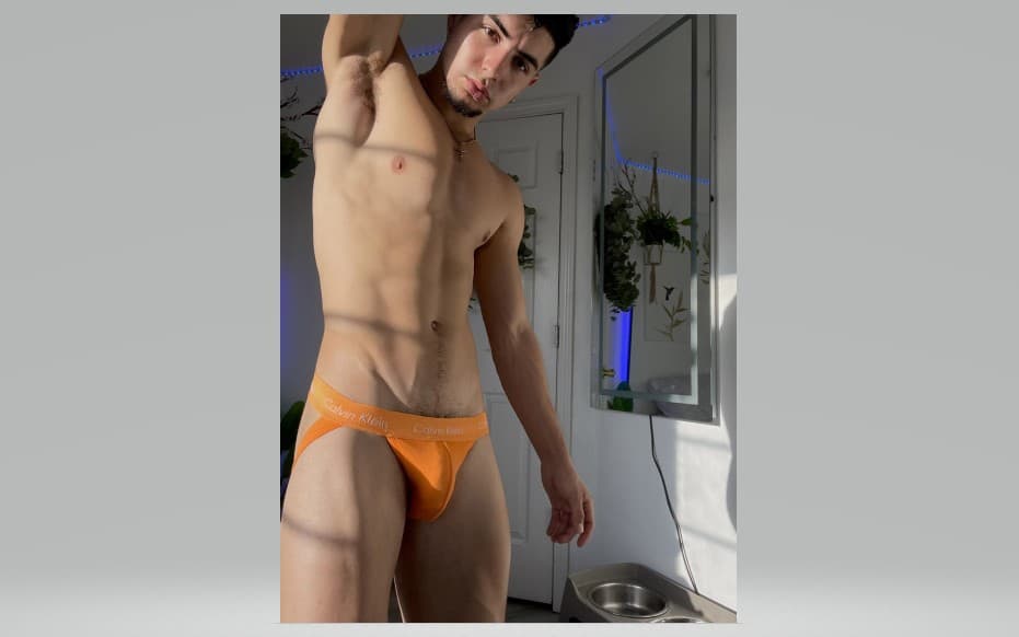 Golden Hour Glow: Athletic Male Portrait in Bright Orange