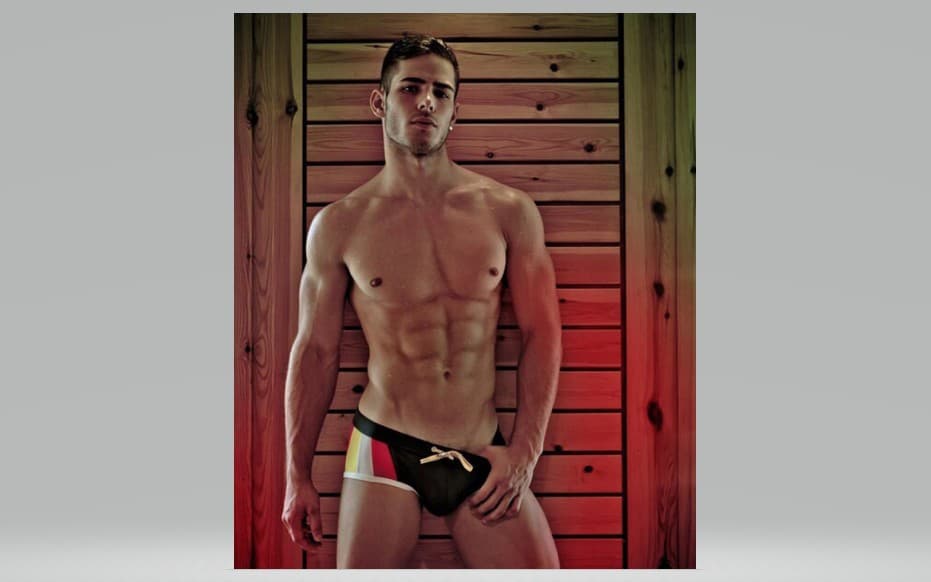Rustic Strength: Athletic Male Portrait against Cedar Wood