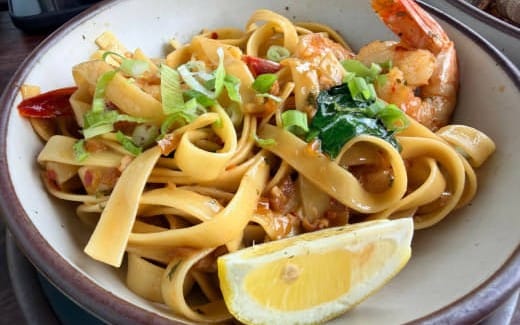 Bowl of pasta with shrimp and lemon wedge in mixed food photography collection digital product