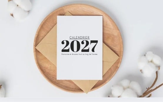 Editable 2027 minimalist calendar template on Canva shown on a wooden board with cotton flowers background