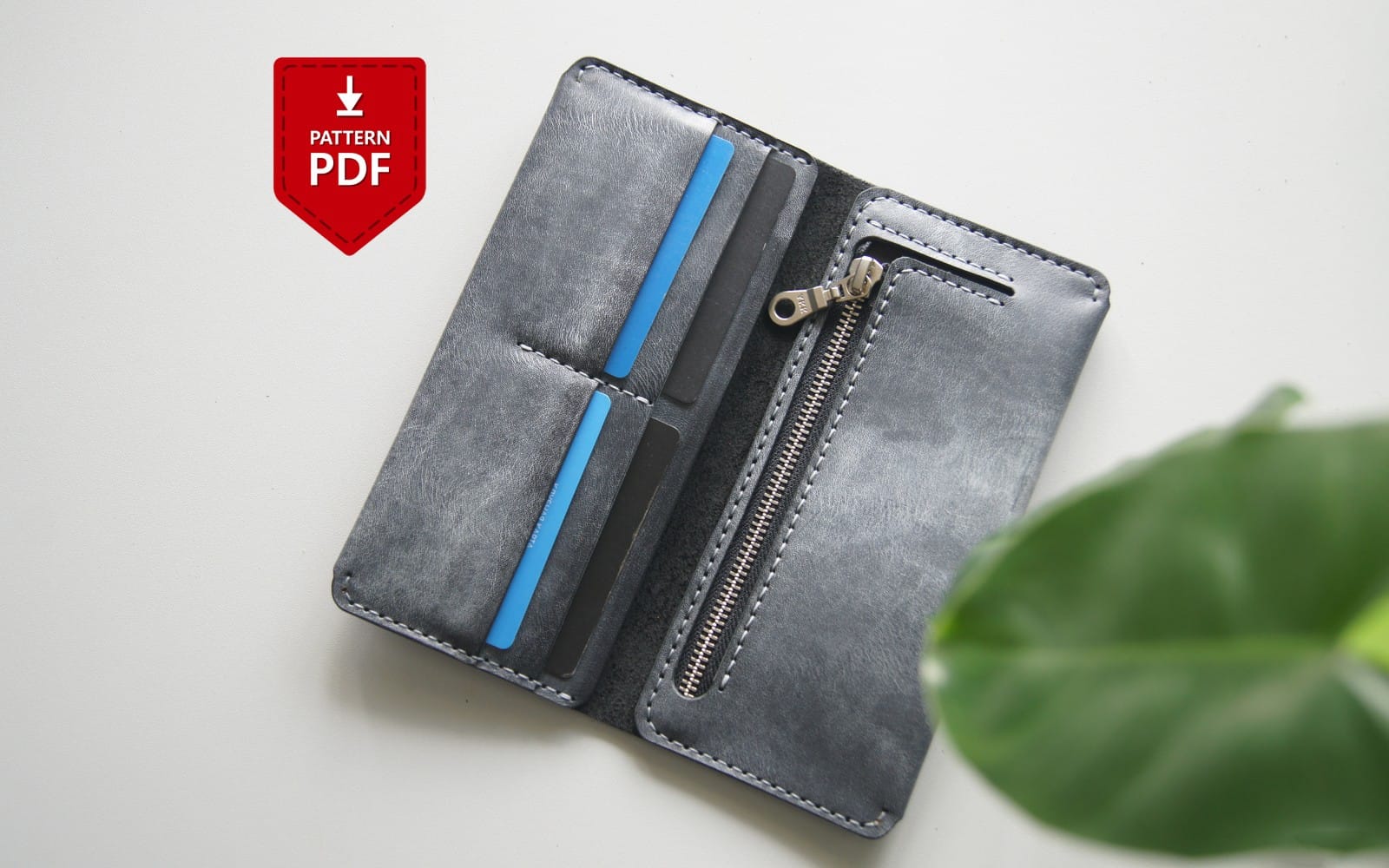 Gray leather long wallet pattern PDF with zipper and card slots shown on a flat lay