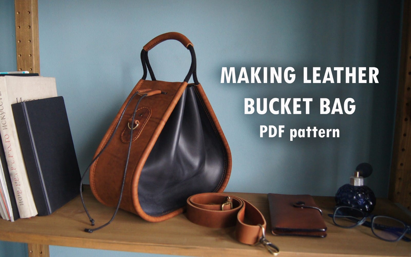 Brown and black leather bucket bag on a workbench with tools, marketing text for making a bucket bag PDF pattern file