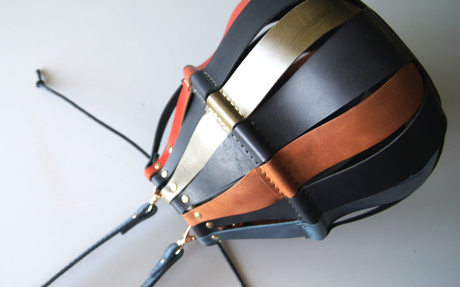 Leather drawstring bag pattern PDF with straps and hardware shown in a close-up product mockup