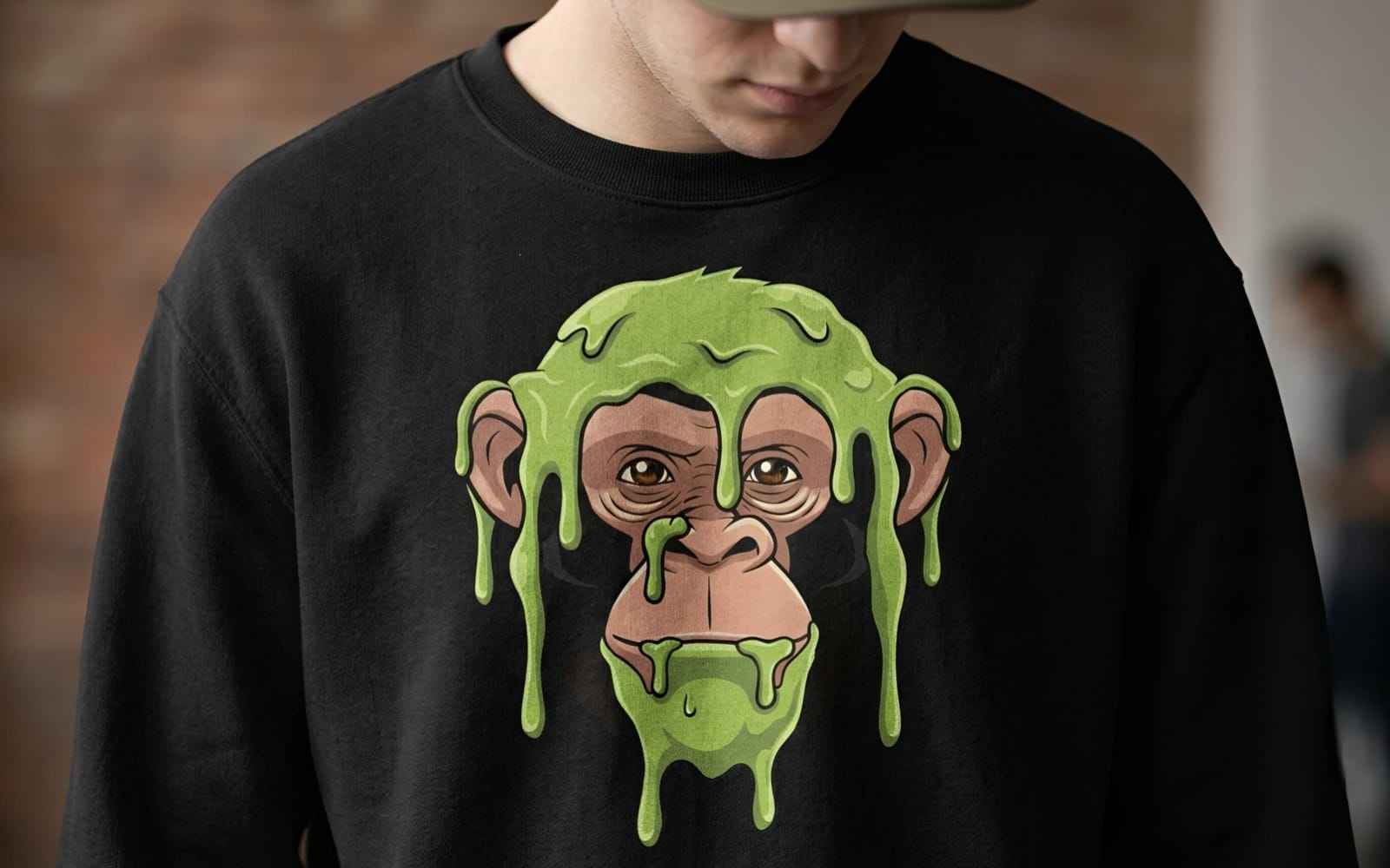 Cartoon chimp face with green slime dripping on a black t-shirt, digital art design mockup