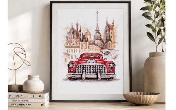 Framed retro Buick cross stitch pattern PDF showing a classic red car and city skyline embroidery design